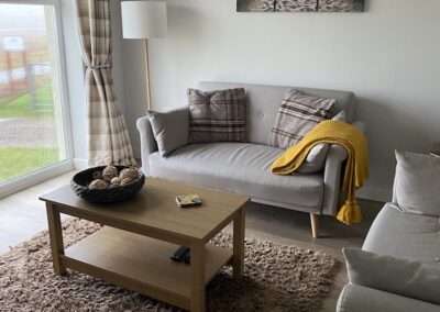 Living room with large window Heisgeir View Holiday Cottage
